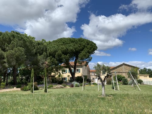 Tuscan-style cottage with large stone pine tree in manicured garden, Thuir, France