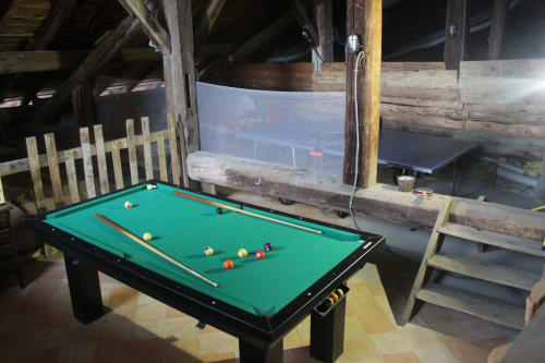 Pool table in rustic wooden game room at La Maison De L'Épine, Aime la Plagne