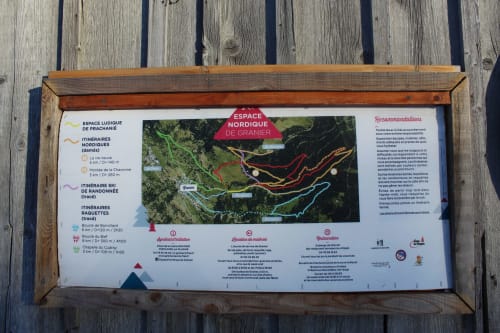 Wooden trail map for Espace Nordique de Granier near Aime la Plagne, showing hiking and skiing routes