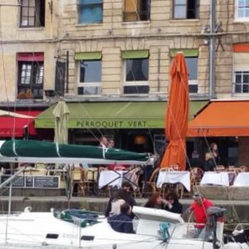 Lunch on the harbor with the green parrot, Honfleur, Normandy.