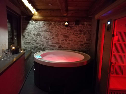 Modern spa bath with red lighting in La Maison De L'Épine cottage, Aime la Plagne mountain resort