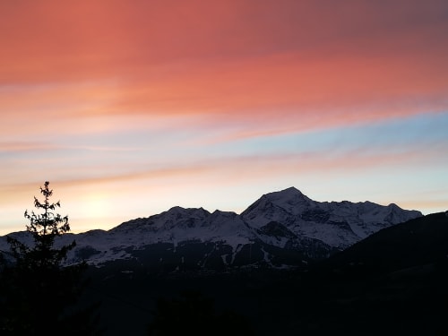 Snow-capped Alpine mountains at sunset above Aime la Plagne, near La Maison De L'Épine