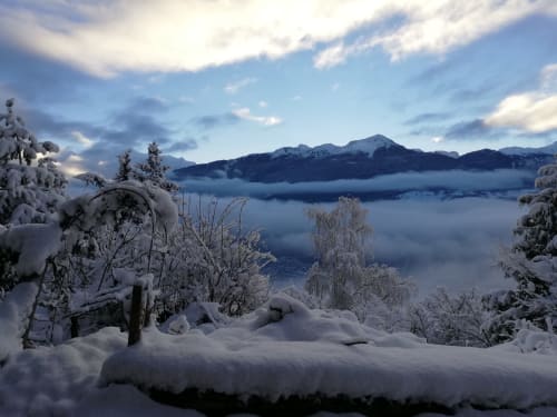 Snow-covered mountain landscape with frozen lake and peaks at La Maison De L'Épine, Aime la Plagne