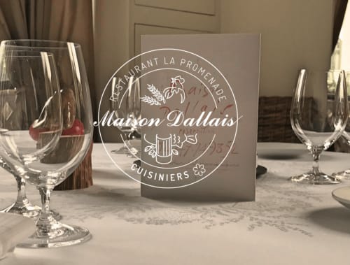 Maison Dallais restaurant table setting with wine glasses and menu card at Château de Ré, Le Petit Pressigny
