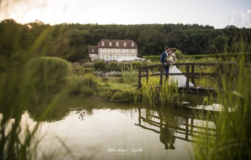 The bride and groom posing at the ponds
