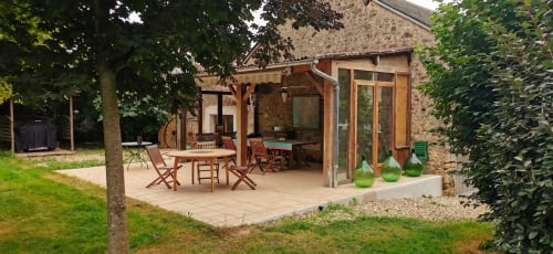 Outdoor patio with wooden furniture and pergola at Aux Prés Du Berry B&B in Chavin, France