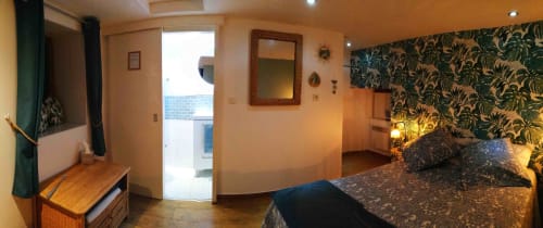 Bedroom at Aux Prés Du Berry B&B in Chavin with floral wallpaper, bed, and door to balcony