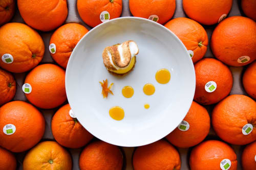 Elegant plated orange dessert with citrus elements at Mas De Lafeuillade, Montpellier B&B surrounded by fresh organic oranges