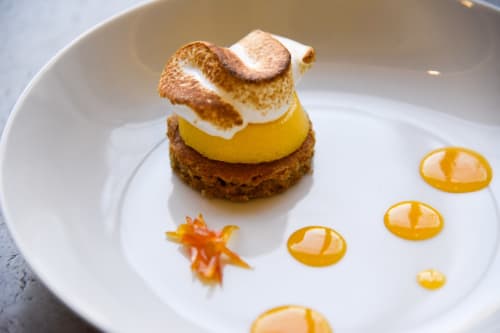 Gourmet lemon meringue dessert with caramelized top at Mas De Lafeuillade, Montpellier
