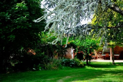 Lush garden with mature trees at Aux Prés Du Berry, a French bed and breakfast in Chavin, Bonnilly