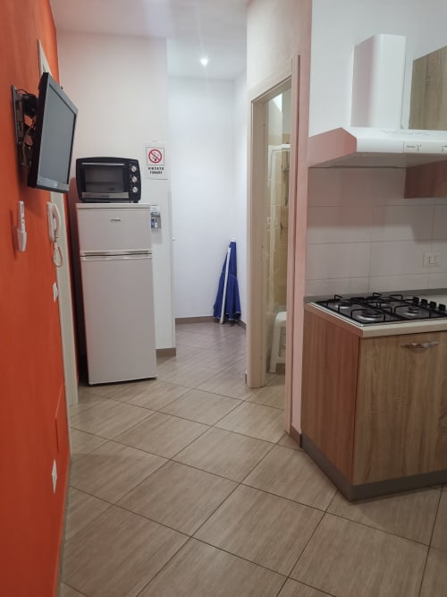 Modern kitchen in Apartment Orange at Casa Vacanze Del Golfo, Castellammare del Golfo, with gas stove, refrigerator, and