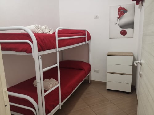 Camera con letto a castello e biancheria rossa presso Casa Vacanze Del Golfo a Castellammare del Golfo, Sicilia