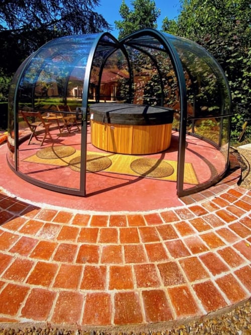 Glass dome spa enclosure with wooden hot tub at Aux Prés Du Berry boutique hotel in Chavin, France