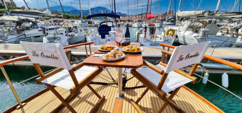 Relaxation and dining in the sun on a yacht in the marina. Eat on the water in peace and with the family. 