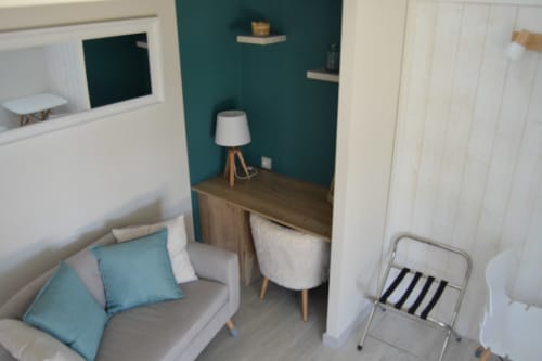 Suite du Meunier room at Logis De La Bénétière with sofa, desk, lamp, and teal accent wall
