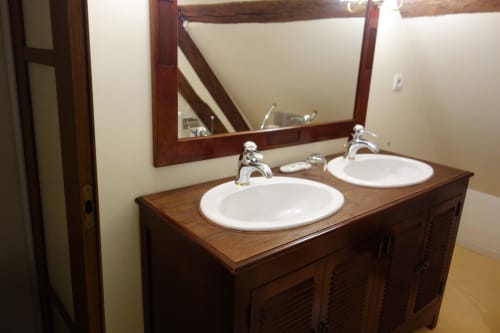 Double sink vanity with wooden frame mirror at Le Fassardy B&B in Châteauroux