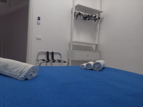 Blue bed with rolled towels in Apartment Sea at Casa Vacanze Del Golfo, Castellammare del Golfo
