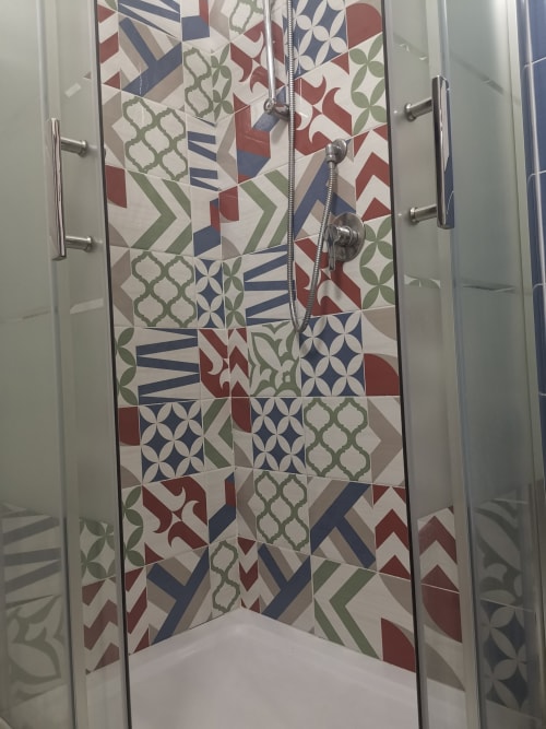 Modern shower enclosure with colorful patterned tile work in Casa Vacanze Del Golfo apartment, Castellammare del Golfo Sicily