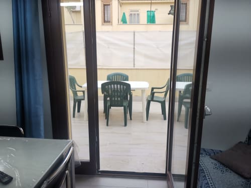 Balcony view with green chairs and table at Casa Vacanze Del Golfo apartment in Castellammare del Golfo, Sicily