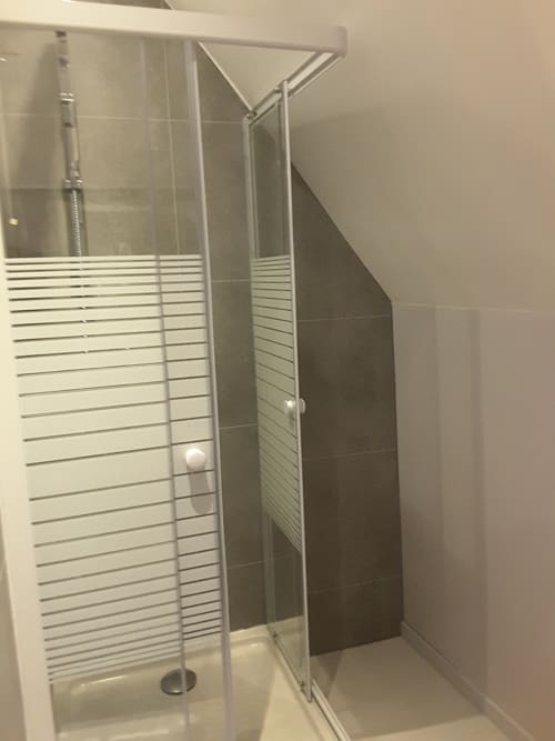 Modern glass shower enclosure with frosted privacy panels at Château de Ré boutique hotel in Le Petit Pressigny