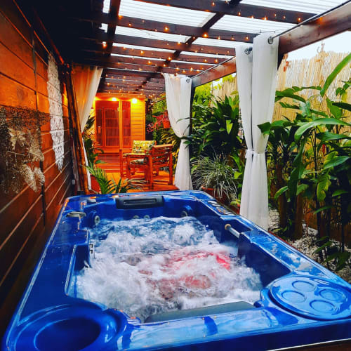 Blue hot tub with bubbling water under pergola at Gites Kaladja, Port-Louis, Guadeloupe