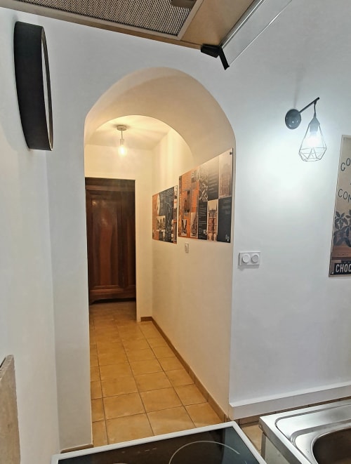 Modern hallway with arched doorway leading to rooms at Locacharme cottage in Blois, France