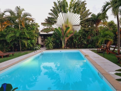 Resort pool surrounded by lush tropical plants at Gites Kaladja in Port-Louis, Guadeloupe
