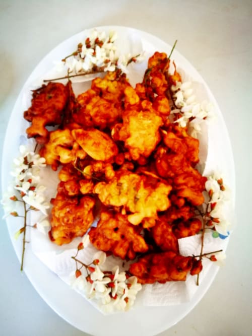 Elegant plated appetizer with crispy orange shrimp and white flowers at Aux Prés Du Berry, Chavin