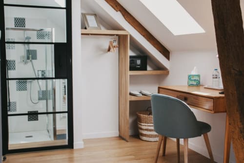 Chambre moderne sous les toits aux Chambres d'hôtes Saint Jean avec bureau en bois, puits de lumière et salle de douche à Nogent le Rotrou