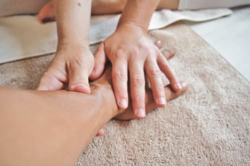 Parent and child hands together on carpet at Les Terrasses Dorées bed and breakfast in Châtillon, France