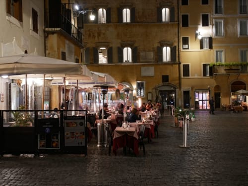 Outdoor dining at Les Terrasses Dorées in Châtillon, France - candlelit restaurant tables under umbrellas in historic