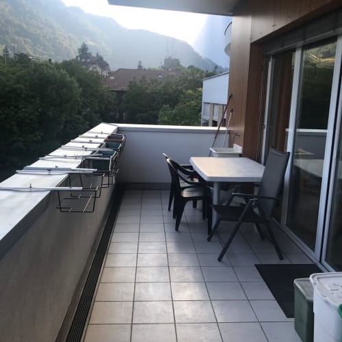 Spacious balcony at Giustina Apartment in Gargazzone with mountain views, dining table, chairs, and access to modern