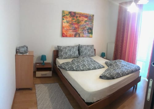 Cozy bedroom at Appartamento Giustina in Gargazzone with double bed, modern furnishings, and mountain views