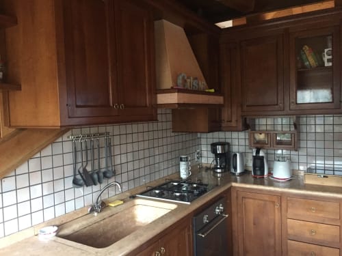 Wooden kitchen with white tile backsplash, gas cooktop, and stainless steel appliances in Apartment Giustina Attic,