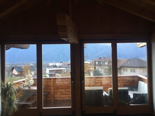 Mountain view from Appartamento Giustina attic apartment in Gargazzone with wooden balcony and village scenery