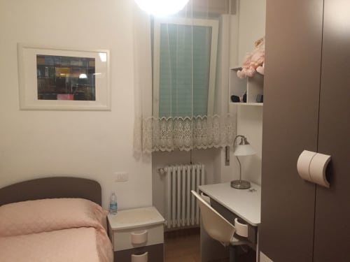 Cozy apartment bedroom in Gargazzone with desk, bed, and window overlooking lake views