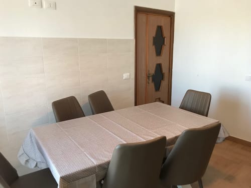 Dining area with table and brown chairs in Lake View Panorama apartment at Appartamento Giustina, Gargazzone