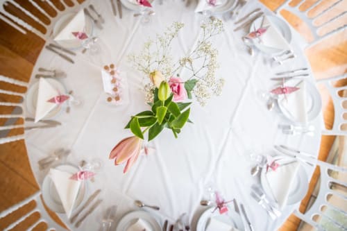 Round table centerpiece with pink tulips and baby's breath at Château de Ré bed and breakfast in Le Petit Pressigny