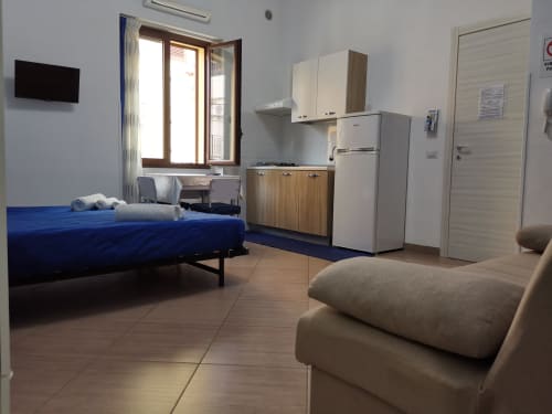 Studio Blu apartment at Casa Vacanze Del Golfo in Castellammare del Golfo with blue bed, kitchenette, and city view