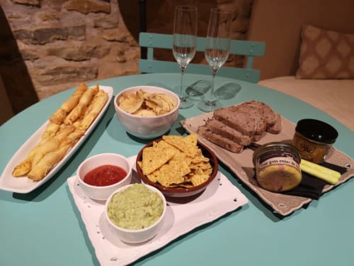 French charcuterie spread with foie gras, bread, chips, and dips at Les Terrasses Dorées in Châtillon