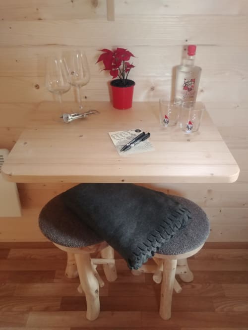 The magic hut, interior with table and stool, unusual accommodation, Jalhay, Belgium.
