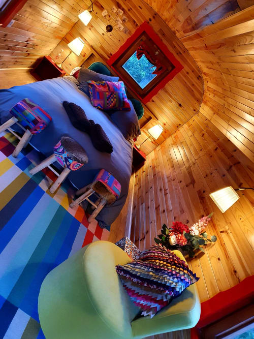 Cozy wooden cottage bedroom at Les Refuges Du Chalet with colorful bedding and garden view window in Jalhay