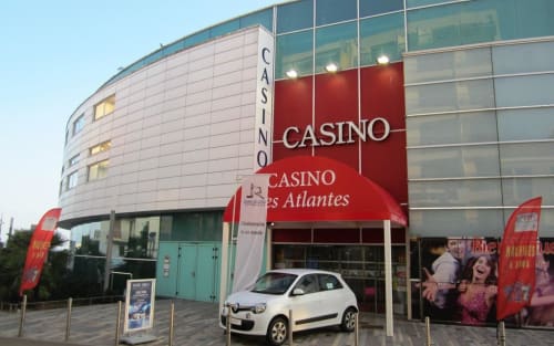Casino Atlantique entrance in Les Sables-d'Olonne with modern architecture and white Renault car parked outside