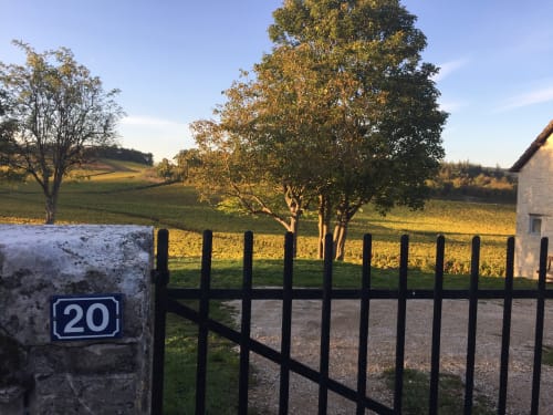 Black gate and stone wall with number 20 marker overlooking autumn vineyards at Les Maisons de Chamirey, Mercurey France