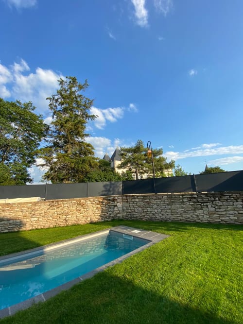 Luxury pool nestled in manicured garden at Les Maisons de Chamirey, Mercurey, with castle views