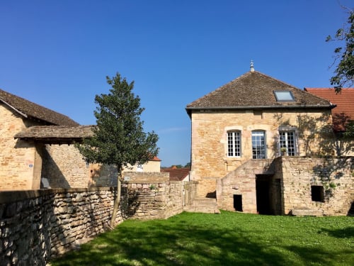 Stone cottages with manicured grounds at Les Maisons de Chamirey, a Mercurey wine country bed and breakfast.