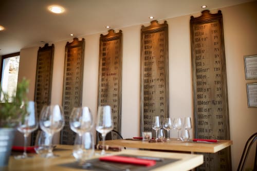 Wine list displays at Les Maisons de Chamirey, Mercurey. Tasting room with glasses and vineyard views.