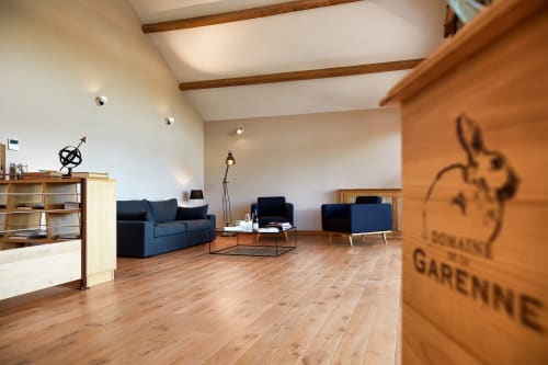 Modern living room with blue furniture and wooden beams at Les Maisons de Chamirey cottage in Mercurey