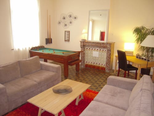 Spacious recreation room at La ferme de l'Ostrevent with pool table, fireplace, seating, and games