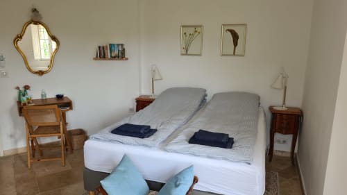 Bright bedroom at La Sentinelle B&B in Les Arcs, featuring twin beds, desk, ornate mirror, and mountain views